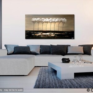 May include: Abstract painting of a row of white trees with brown trunks against a brown background. The painting is displayed on a wall in a living room setting with a white couch, a coffee table, and a floor lamp.