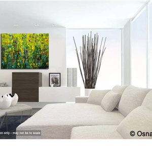 May include: An abstract painting of a field of flowers in shades of yellow, green, blue, and purple hangs on a white wall. The living room features a white sofa, modern decor, and a large window. The artwork is signed by OsnatFineArt.