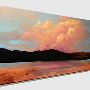 May include: A painting of a landscape with a large pink and orange cloud in the sky above a dark mountain range and a body of water. The sky is a light blue and the water is a light blue with a reflection of the sky.