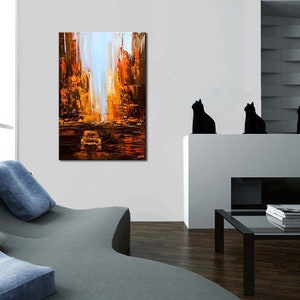 May include: Abstract painting of a city street scene with tall buildings in shades of orange, yellow, and brown. A car is visible in the distance.