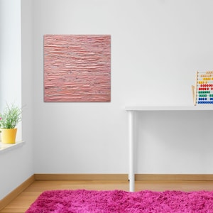May include: A pink abstract painting with horizontal brushstrokes hangs on a white wall above a white desk with a wooden abacus. The desk is in a room with a window and a pink rug.