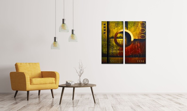 May include: Abstract art print in a modern style with a yellow, brown, and gold color scheme. The print is divided into two panels, each featuring a large circle with a textured background.
