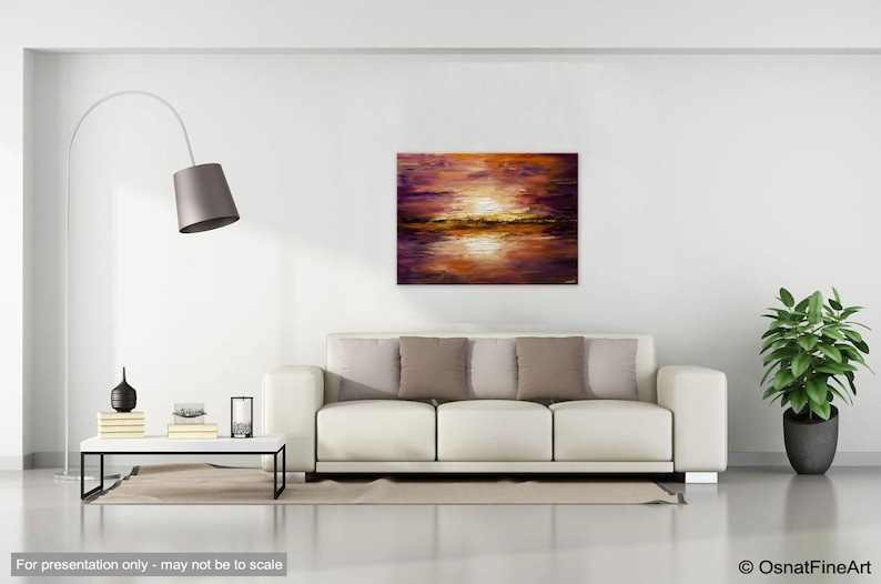 May include: A painting of a sunset over a body of water. The sky is a mix of purple, orange, and pink, with a bright yellow sun in the center. The water is a dark blue, reflecting the colors of the sky.