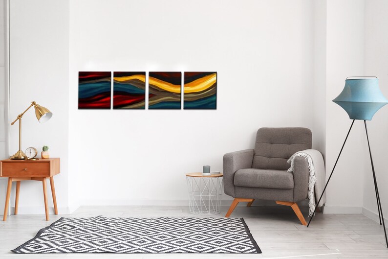 May include: A four-piece abstract art print set featuring a colorful, wavy design in shades of blue, red, yellow, and brown. The prints are framed in black and hung on a white wall in a living room setting.