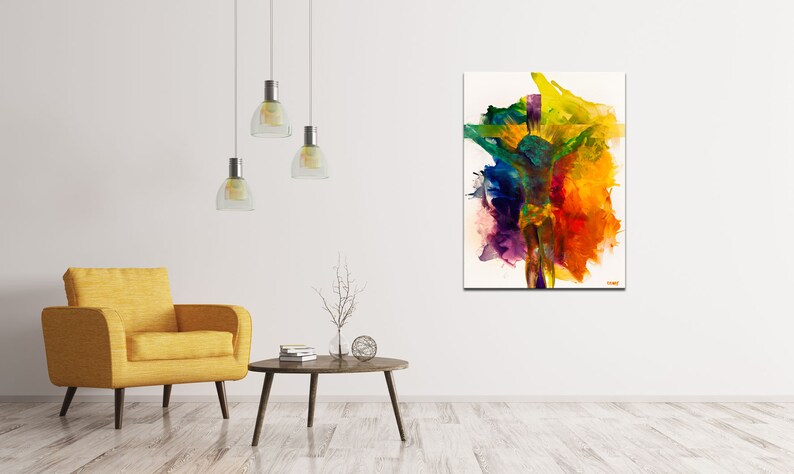 May include: Abstract painting with vibrant colors, including yellow, orange, red, green, blue, and purple, on a white background. The painting is displayed in a living room setting with a yellow armchair and a coffee table.