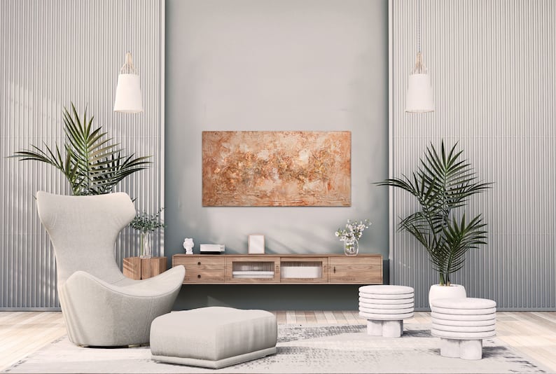 May include: A modern living room with a neutral color palette. Features a large abstract painting, a wooden media console, a comfortable armchair, and two small side tables. Potted plants and pendant lights add a touch of nature and elegance.