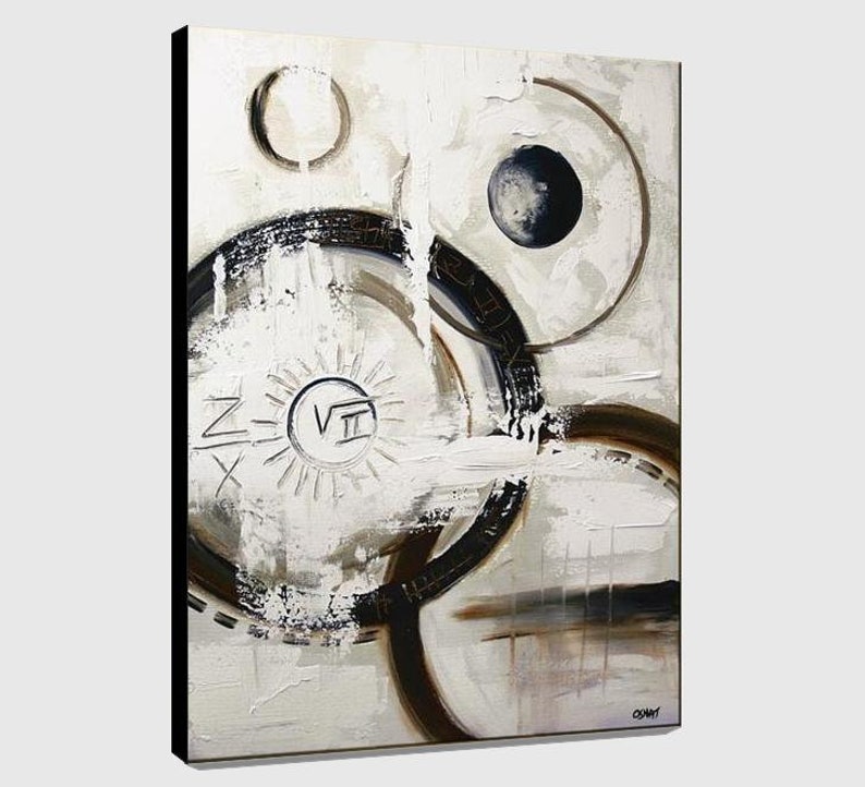 May include: Abstract painting with a white background and black, brown, and gray circles. The painting has a sun-like design in the center with the Roman numeral VII.
