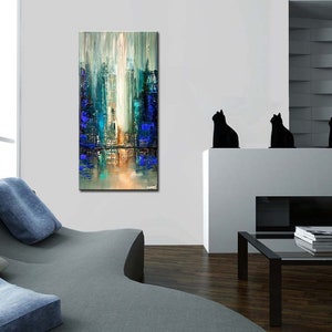 May include: Abstract painting depicting a city skyline in shades of blue, green, and white. The artwork is displayed on a white wall in a contemporary living room.
