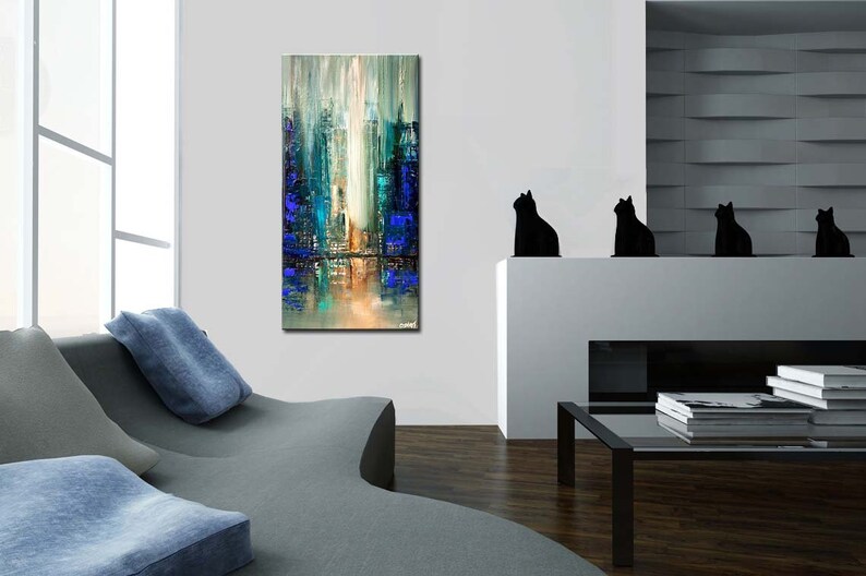 May include: Abstract painting depicting a city skyline in shades of blue, green, and white. The artwork is displayed on a white wall in a contemporary living room.