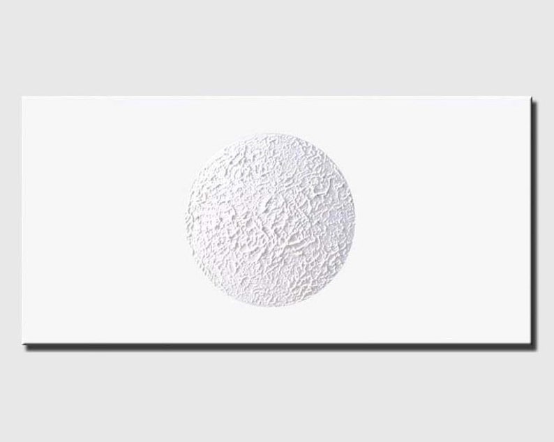 May include: A white textured circle on a white background. The circle has a rough, uneven surface.