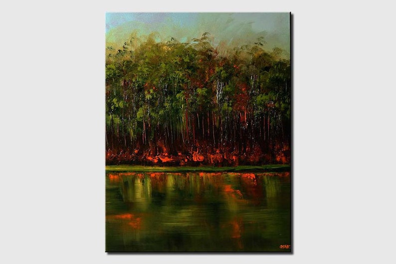May include: A painting of a forest reflected in a still lake. The trees are a deep green with hints of red and orange, creating a warm and inviting scene.