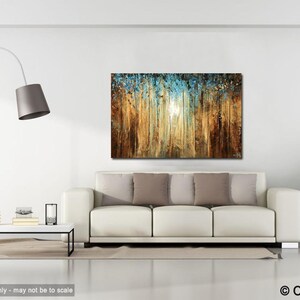 May include: Abstract painting of a forest scene with a blue and gold color scheme. The painting is hanging on a white wall above a white couch with brown pillows.