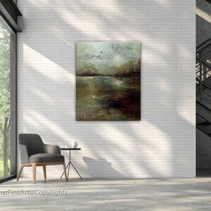May include: Abstract landscape painting with shades of green, brown, and white. The painting is hanging on a white brick wall in a modern interior setting.