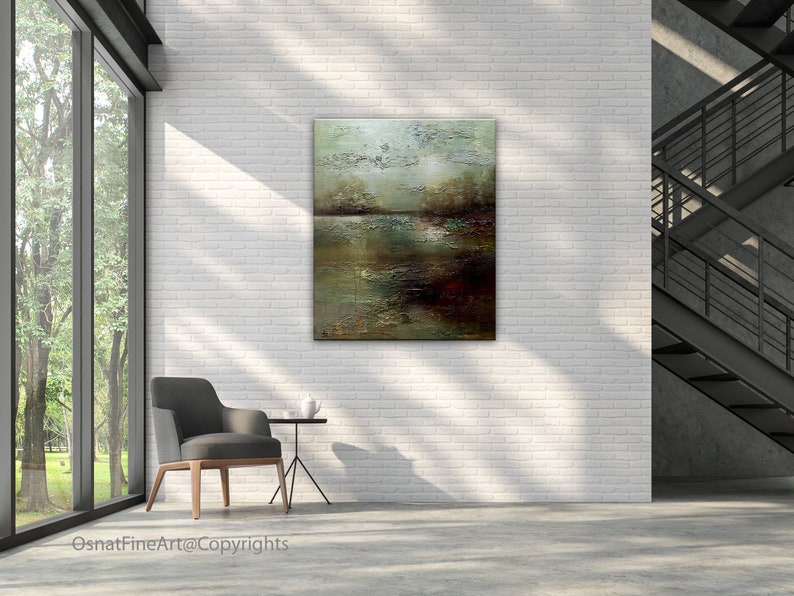 May include: Abstract landscape painting with shades of green, brown, and white. The painting is hanging on a white brick wall in a modern interior setting.