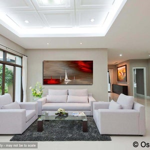 May include: A living room interior with white couches and a coffee table. A large abstract painting of a red sunset with white sailboats hangs on the wall.