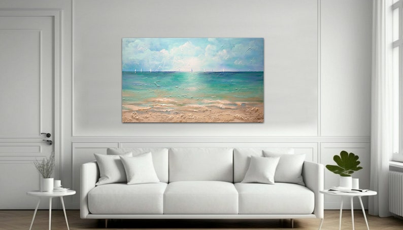 May include: A painting of a seascape with a sandy beach and blue water. The sky is a light blue with white clouds. There are sailboats in the distance.