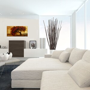 May include: A white sectional sofa with multiple pillows in a modern living room. A painting of a red tree on a gold background hangs on the wall.
