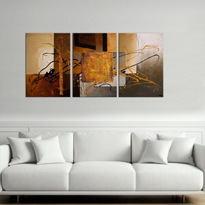May include: Abstract art print in a tri-panel set. The print features a mix of brown, gold, and black colors with abstract shapes and lines.