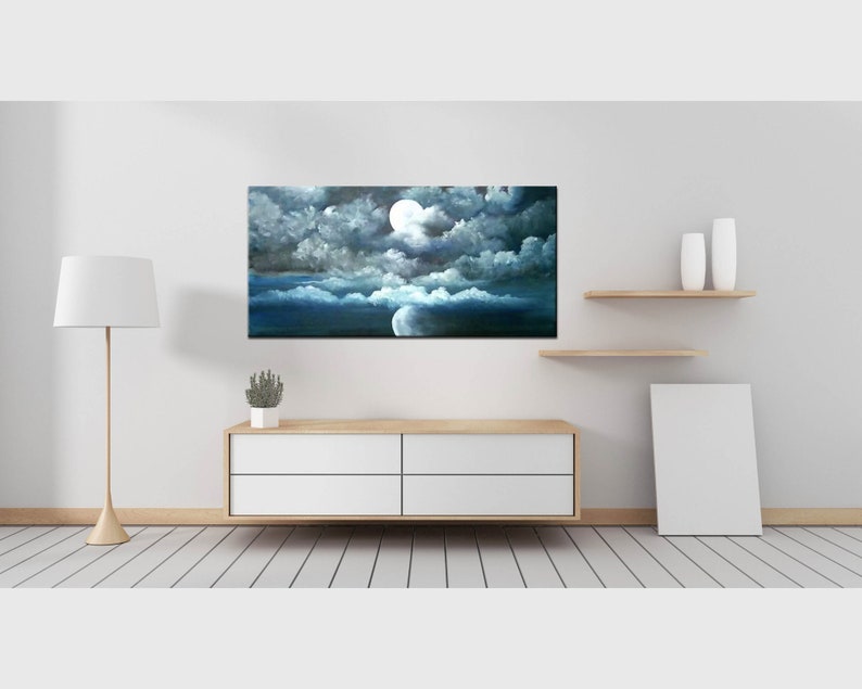 May include: A painting of a night sky with a full moon and clouds. The clouds are a dark gray and the moon is a bright white. The sky is a dark blue.