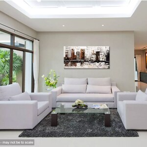 May include: A modern living room with white couches and a glass coffee table. A large abstract painting of a cityscape in shades of brown, white, and gray hangs on the wall.