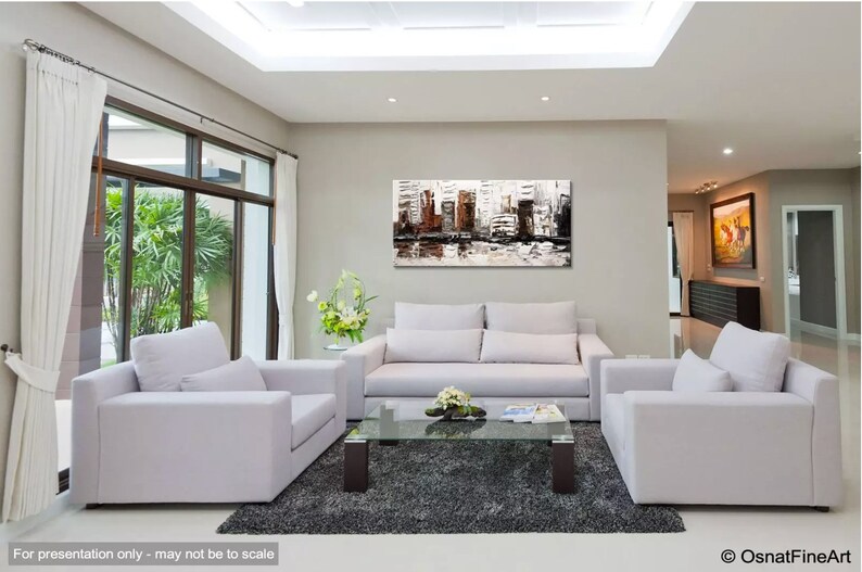 May include: A modern living room with white couches and a glass coffee table. A large abstract painting of a cityscape in shades of brown, white, and gray hangs on the wall.