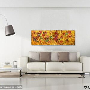 May include: Abstract painting with a yellow background and red, green, and blue accents. The painting is displayed on a white wall above a white sofa with beige pillows.