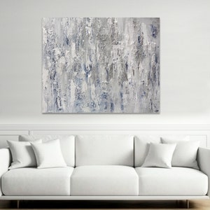 May include: Abstract painting with a textured, layered look. The painting features shades of gray and blue, creating a calming and modern aesthetic.