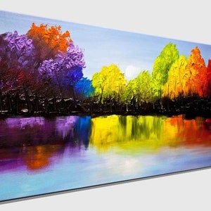 May include: A colorful abstract painting of a forest reflected in a still lake. The trees are painted in shades of purple, orange, yellow, green, and blue. The water is a light blue with reflections of the trees.