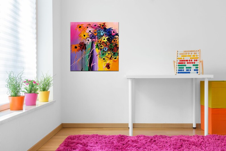 May include: Abstract painting of a colorful flower bouquet with yellow, orange, pink, purple, blue, and green hues. The painting is on a white wall in a room with a white desk and a wooden abacus.