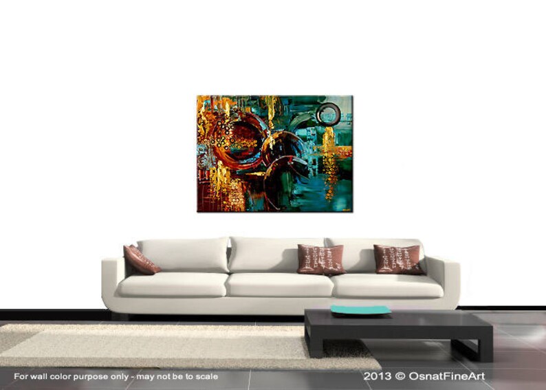 May include: Abstract painting with a mix of teal, blue, gold, and brown colors. The painting features overlapping circles and geometric shapes.