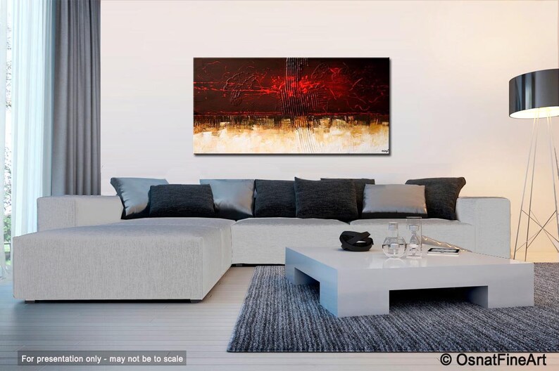 May include: Abstract painting with red, brown, and white colors. The painting is hanging on a white wall above a white sectional sofa with black pillows. A white coffee table with a black bowl and clear glasses sits in front of the sofa.