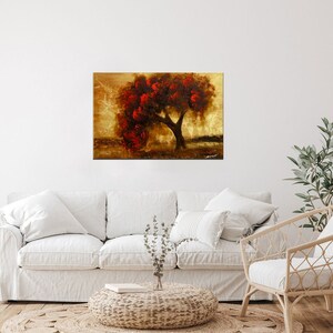 May include: A painting of a lone tree with red leaves against a golden background. The tree is in the center of the canvas and is surrounded by a soft, golden light. The painting has a warm and inviting feel.