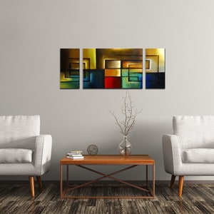 May include: A set of four abstract paintings with geometric shapes in shades of blue, green, yellow, red, and brown. The paintings are arranged in a horizontal row on a white wall above a wooden coffee table.