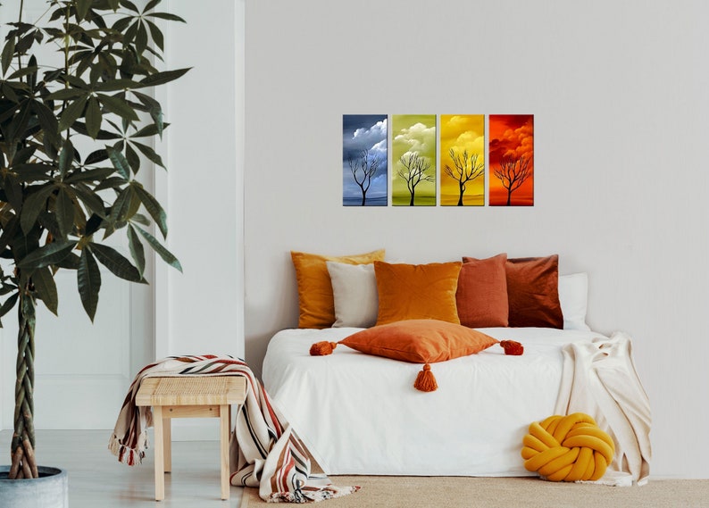 May include: Four framed canvas prints depicting a bare tree in different seasons. The prints are arranged in a row, with the first showing a blue sky with clouds, the second showing a yellow sky with clouds, the third showing a green sky with clouds, and the fourth showing a red sky with clouds.