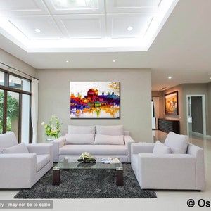 May include: A colorful abstract painting of a cityscape with a white background. The painting is displayed on a wall in a living room with white furniture and a gray rug.