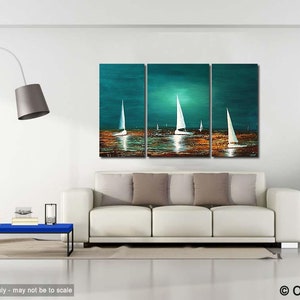 May include: A three-piece abstract painting of sailboats on a teal blue ocean with a golden sunset. The painting is displayed on a white wall above a white couch with brown throw pillows.