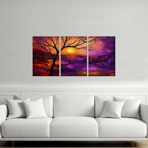 May include: A three-piece canvas print set featuring a silhouette of a tree with branches reaching towards a setting sun. The background is a vibrant mix of purple, orange, and yellow hues.