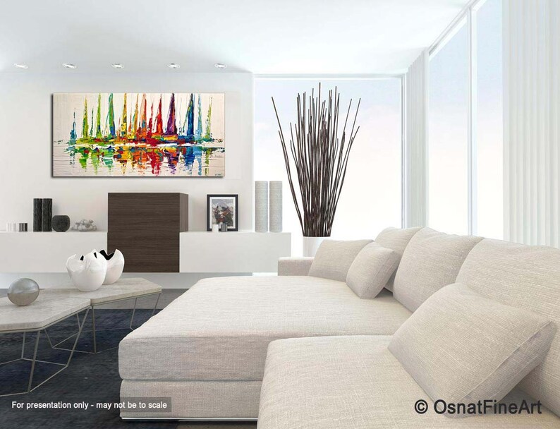 May include: Abstract painting of colorful sailboats on a white background, displayed in a modern living room with a white couch and a vase of brown branches.