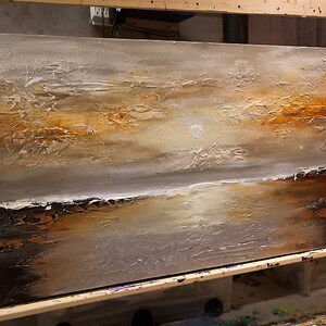 May include: Abstract painting on canvas with textured brushstrokes in shades of brown, white, and gray. The painting depicts a landscape with a horizon line and a sky with a white sun.