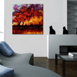 May include: A painting of a large red tree with purple leaves in a forest setting. The tree is in the center of the painting and is surrounded by other trees and bushes. The background is a soft, golden light.