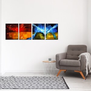May include: Four abstract paintings in a modern living room setting. The paintings are in a grid formation and feature a mix of red, orange, blue, and green colors. The paintings are framed in black and hung on a white wall.