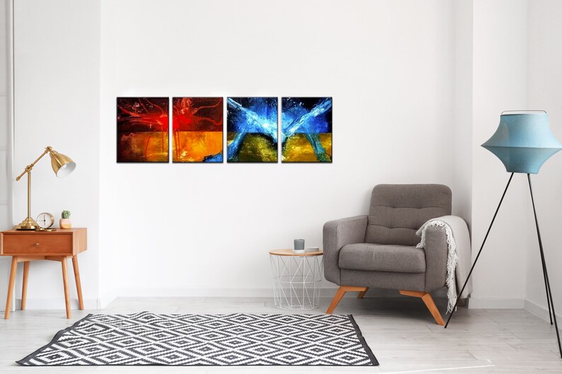 May include: Four abstract paintings in a modern living room setting. The paintings are in a grid formation and feature a mix of red, orange, blue, and green colors. The paintings are framed in black and hung on a white wall.