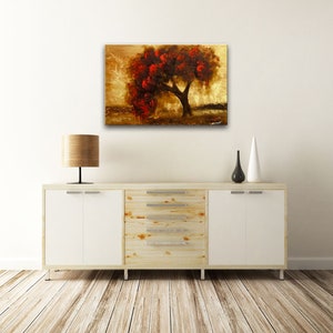 May include: A painting of a tree with red leaves against a gold background. The tree is in the center of the painting and is surrounded by a field of grass. The sky is a light blue color.