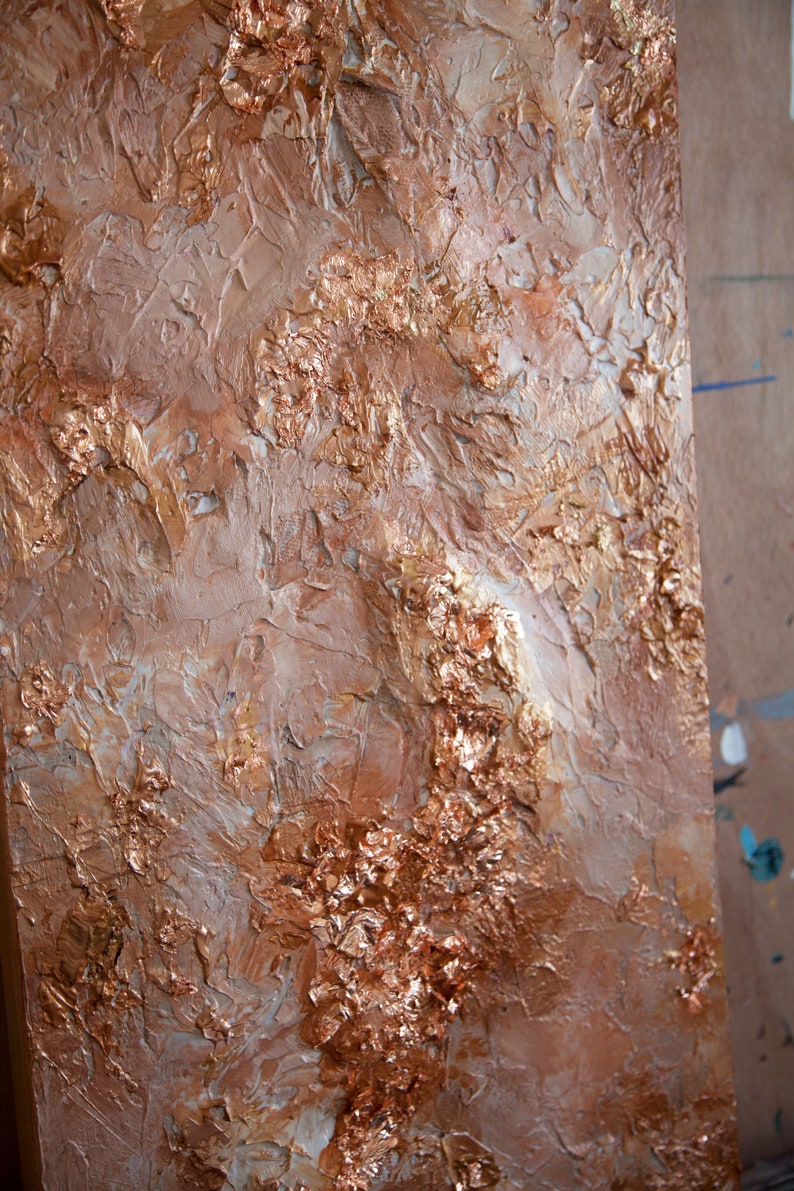 May include: Abstract painting with a textured, layered surface. The painting features shades of brown, gold, and white, creating a metallic and earthy effect.