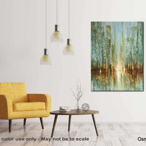 May include: Abstract painting of a city skyline with gold and green hues. The painting is displayed on a white wall in a living room setting with a yellow armchair and a coffee table.
