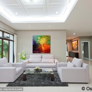May include: A colorful abstract painting with yellow, green, blue, and orange hues hangs on a wall in a living room. The painting is above a white sofa with two white armchairs and a glass coffee table.