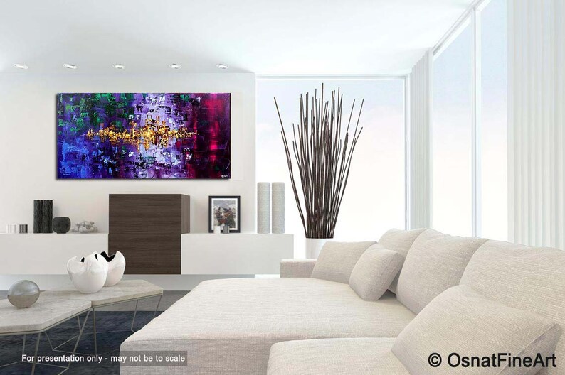 May include: Abstract painting with purple, blue, green, and gold hues. The painting is displayed on a white wall in a modern living room setting.