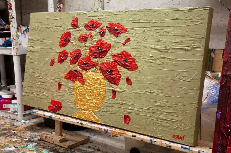 May include: A painting of a bouquet of red poppies in a gold vase on a textured green background. The artist's signature is visible in the lower right corner.