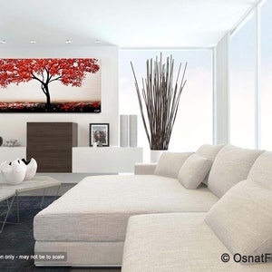 May include: Abstract painting of a red tree with a white trunk against a light gray background. The painting is displayed on a white wall in a living room setting with a white couch and pillows.