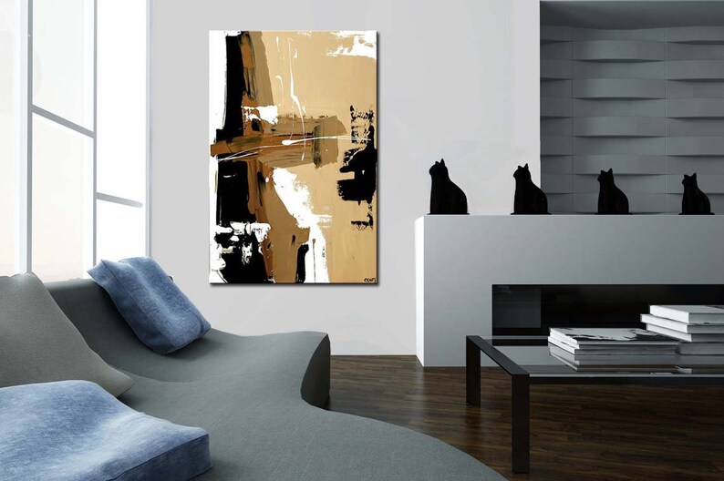 May include: Abstract painting with black, white, and brown brushstrokes on a canvas. The painting is hanging on a white wall in a modern living room.